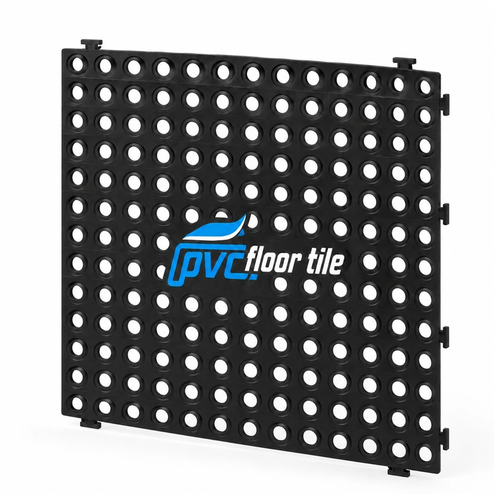 Black Duckboard Interlocking Tiles – Drainage Flooring Black Duckboard Interlocking Tiles with open-grid drainage holes and interlocking edges, held upright to show the tile design