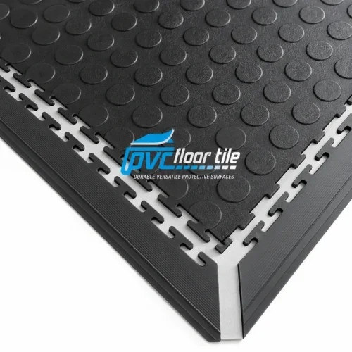Black Garage Floor Ramp Edge with ribbed sloping strips fitted to interlocking PVC tiles with a raised coin pattern