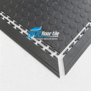 Garage floor ramp edge fitted to black coin pattern interlocking PVC tile